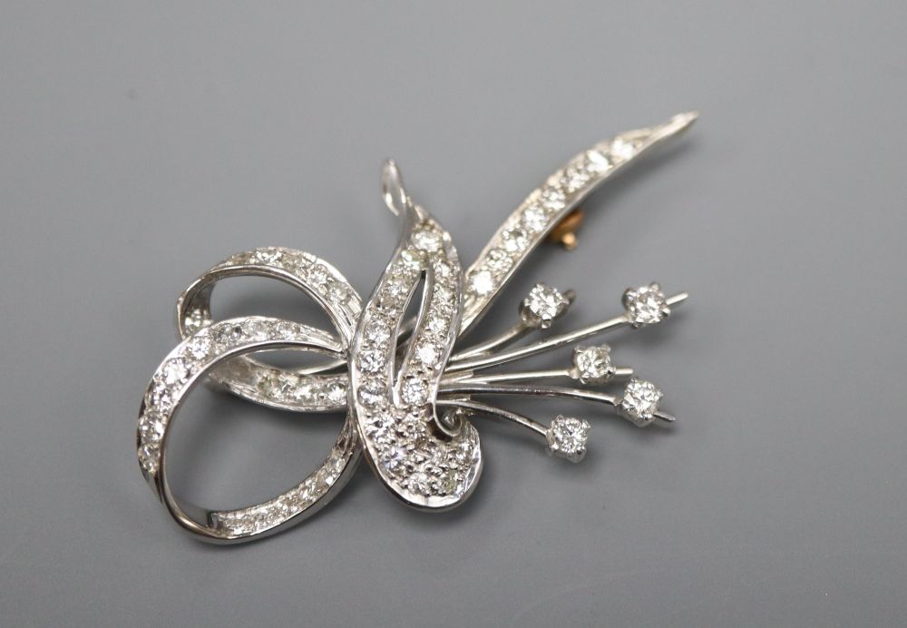 An 18ct white gold? and diamond scroll and spray brooch, 4.5cm, gross 7.8 grams